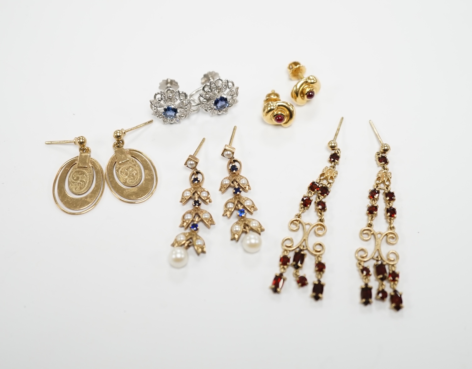 Three pairs of assorted 9ct gold earrings including two gem set, a pair of white metal (stamped 18) and gem set ear clips and a pair of 18k and cabochon ruby ear studs.